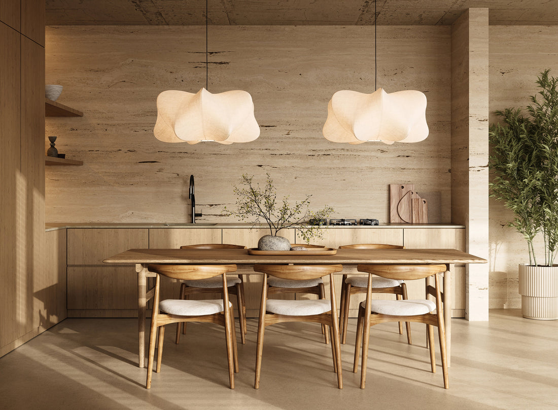 Dining and kitchen interior combining daylight with layered artificial lighting.