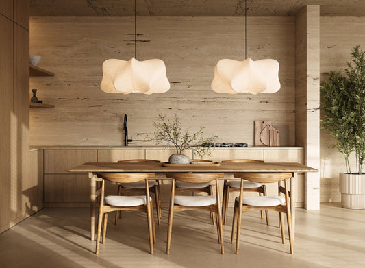Dining and kitchen interior combining daylight with layered artificial lighting.